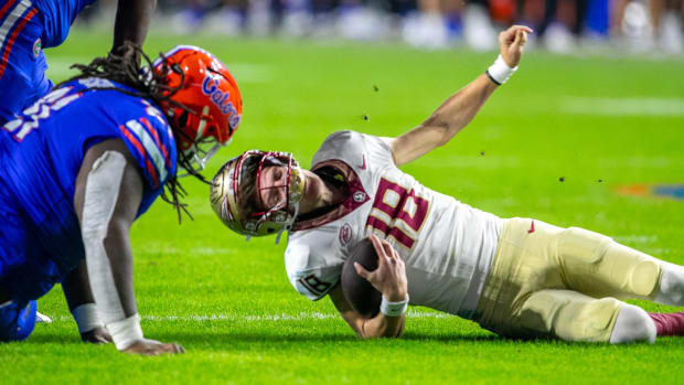 Florida Gators defensive lineman Desmond Watson (21) sacks Florida State Seminoles quarterback Tate Rodemaker (18) during second half action as Florida takes on Florida State at Steve Spurrier Field at Ben Hill Griffin Stadium in Gainesville, FL on Saturday, November 25, 2023.
